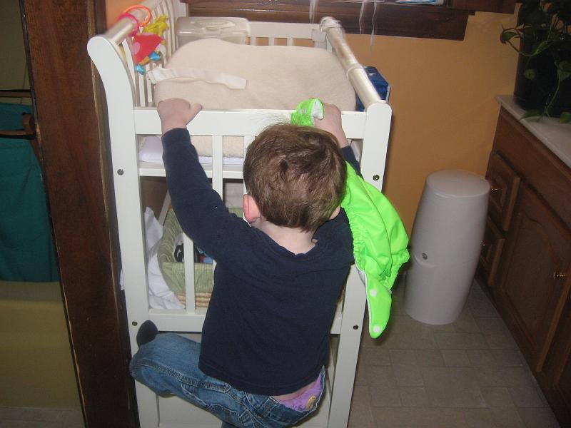 IMG_1008.JPG - Time for a new diaper.  He loves the neon green ones.