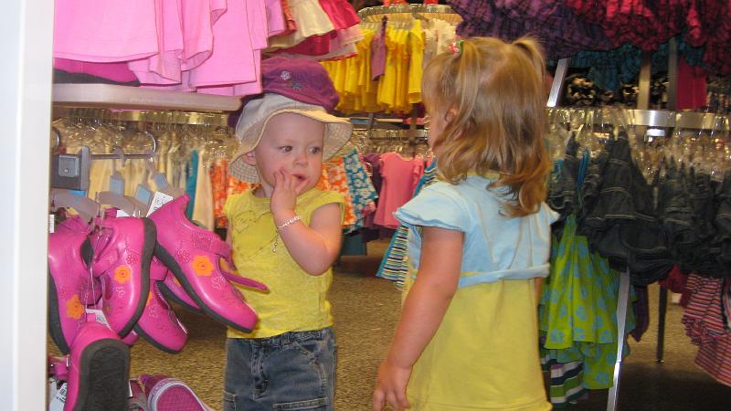 IMG_2643.JPG - She picked out a hat at The Childrens Place outlet and put it on.  This little girl was intrigued (or maybe just confused).